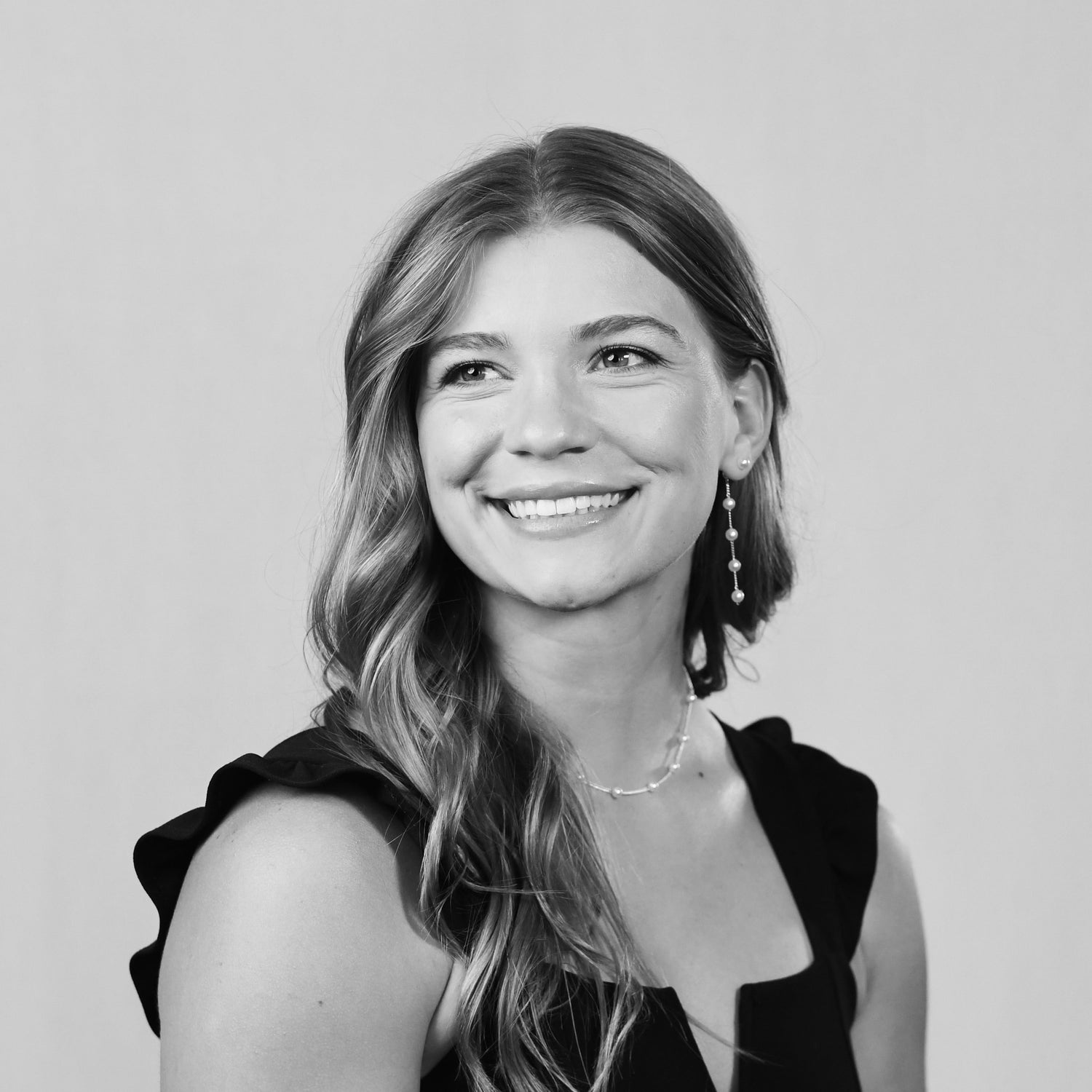 Black and white portrait of a woman with a neutral background
